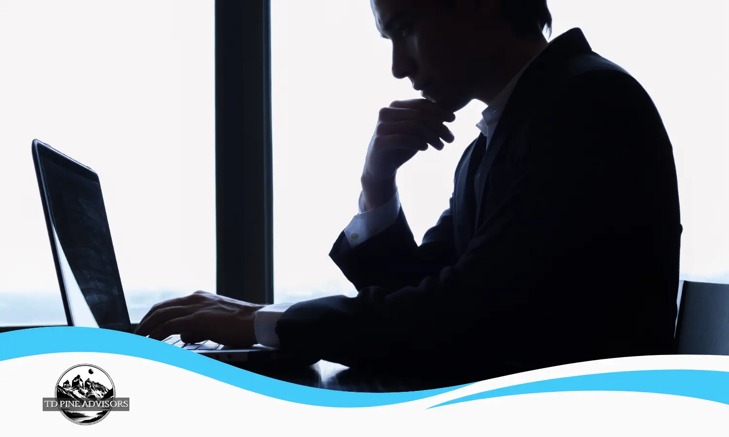 Business owner sitting at a laptop, looking thoughtful while analyzing why their business growth has stalled