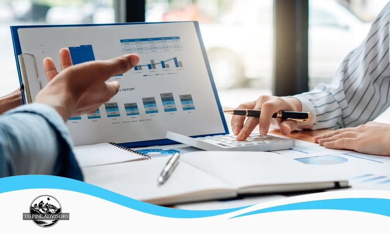 Business owner reviewing financial reports and analyzing the key factors that impact business valuation